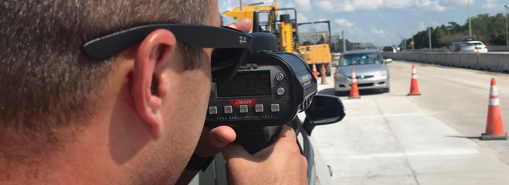 A police officer trains with using a speed radar gun