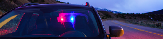 Car pulled over by police on a highway at dusk